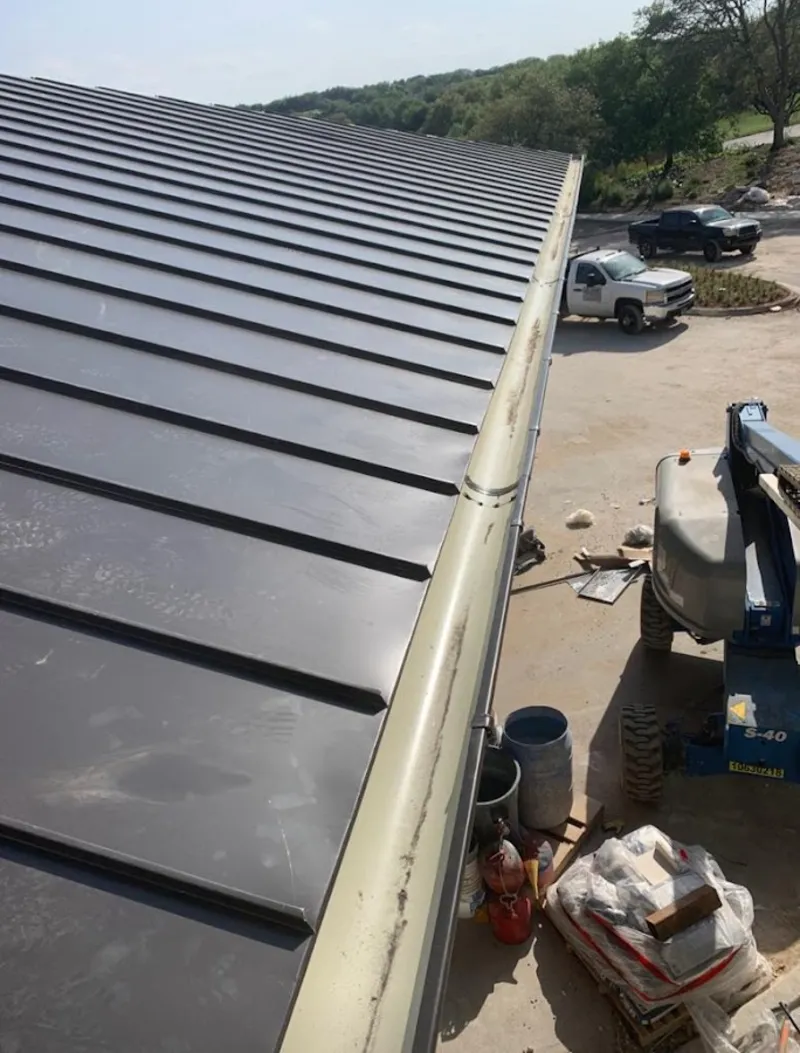 Standing seam panel and gutter detail on a metal roofing jobsite in Mountain Home